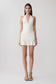 Woman wearing a white halter mini dress.