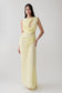Woman wearing a light yellow chiffon maxi dress.