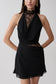 Woman wearing a black chiffon And lace halter mini dress.