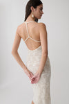 Woman wearing a white lace midi dress.