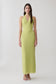 Woman wearing a light green halter maxi dress.