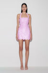 Woman wearing pink sequin halter mini dress.