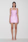 Woman wearing pink sequin halter mini dress.