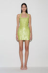Woman wearing a green sequin halter mini dress.