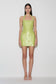Woman wearing a green sequin halter mini dress.