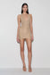 Woman wearing a gold lurex halter mini dress