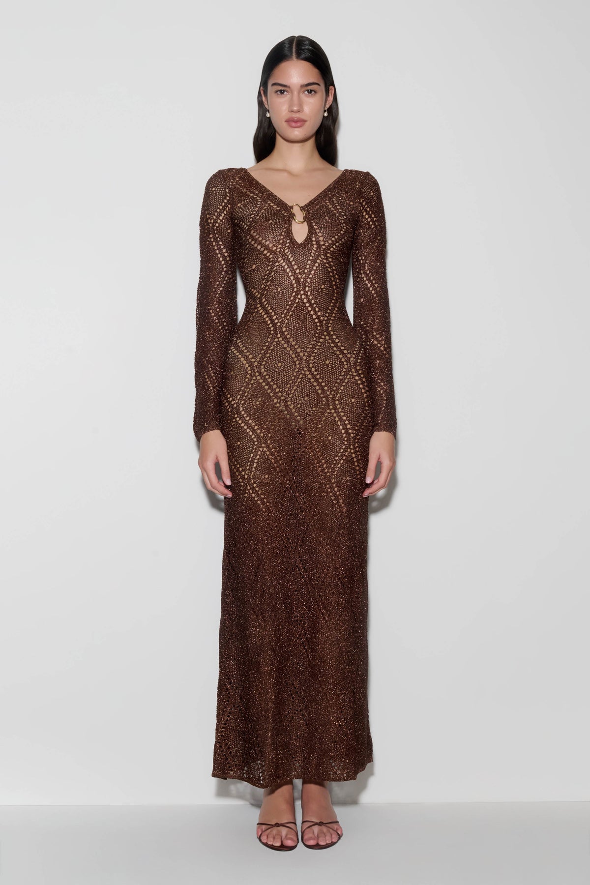 Woman wearing a brown lurex crochet maxi dress.