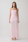 Woman wearing a pink strapless ruched mesh maxi dress.