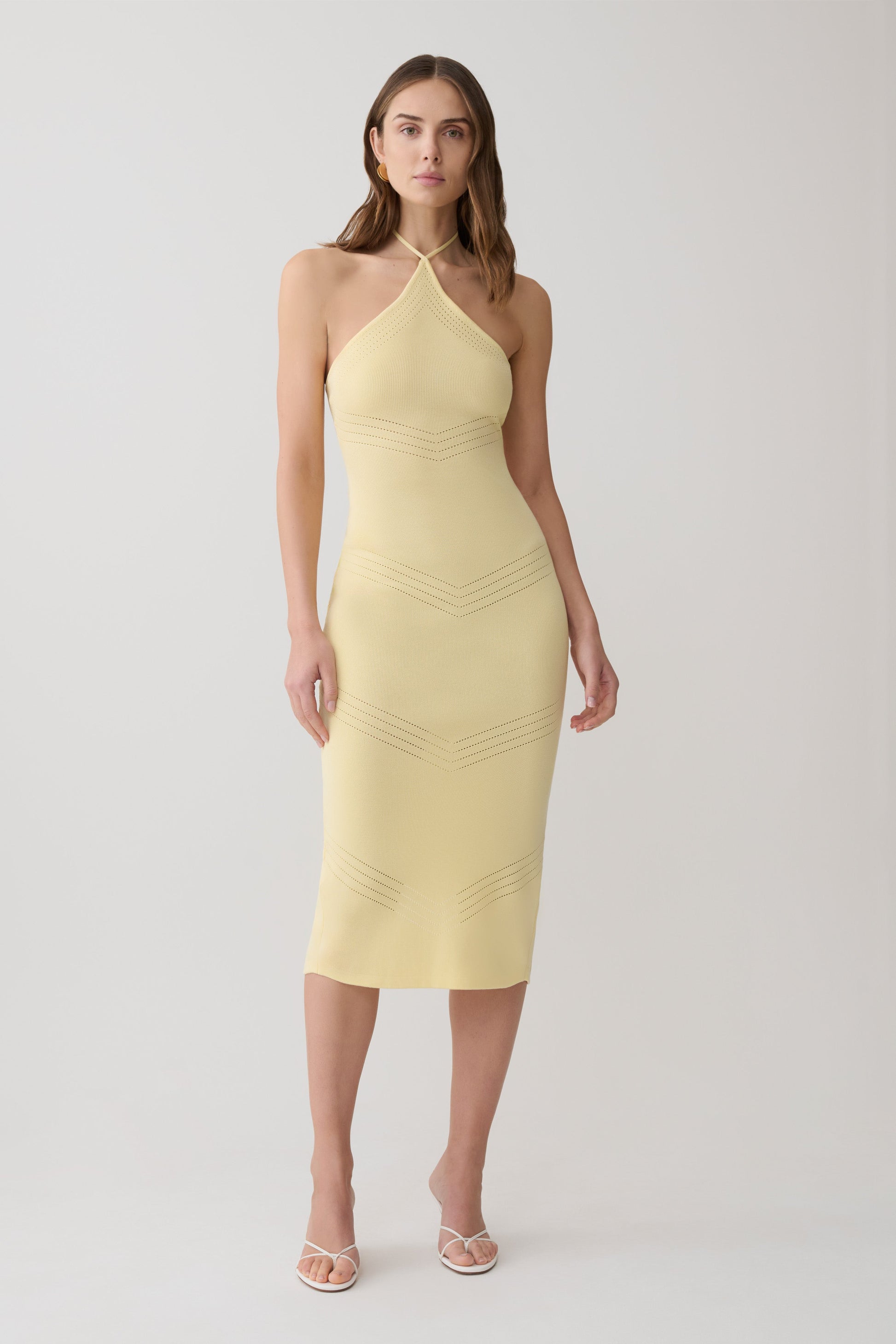 Woman wearing a yellow pointelle midi dress.