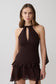 Woman wearing a brown chiffon halter sleeveless top with matching mini skirt.