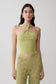 Woman wearing a green twist front knit top.