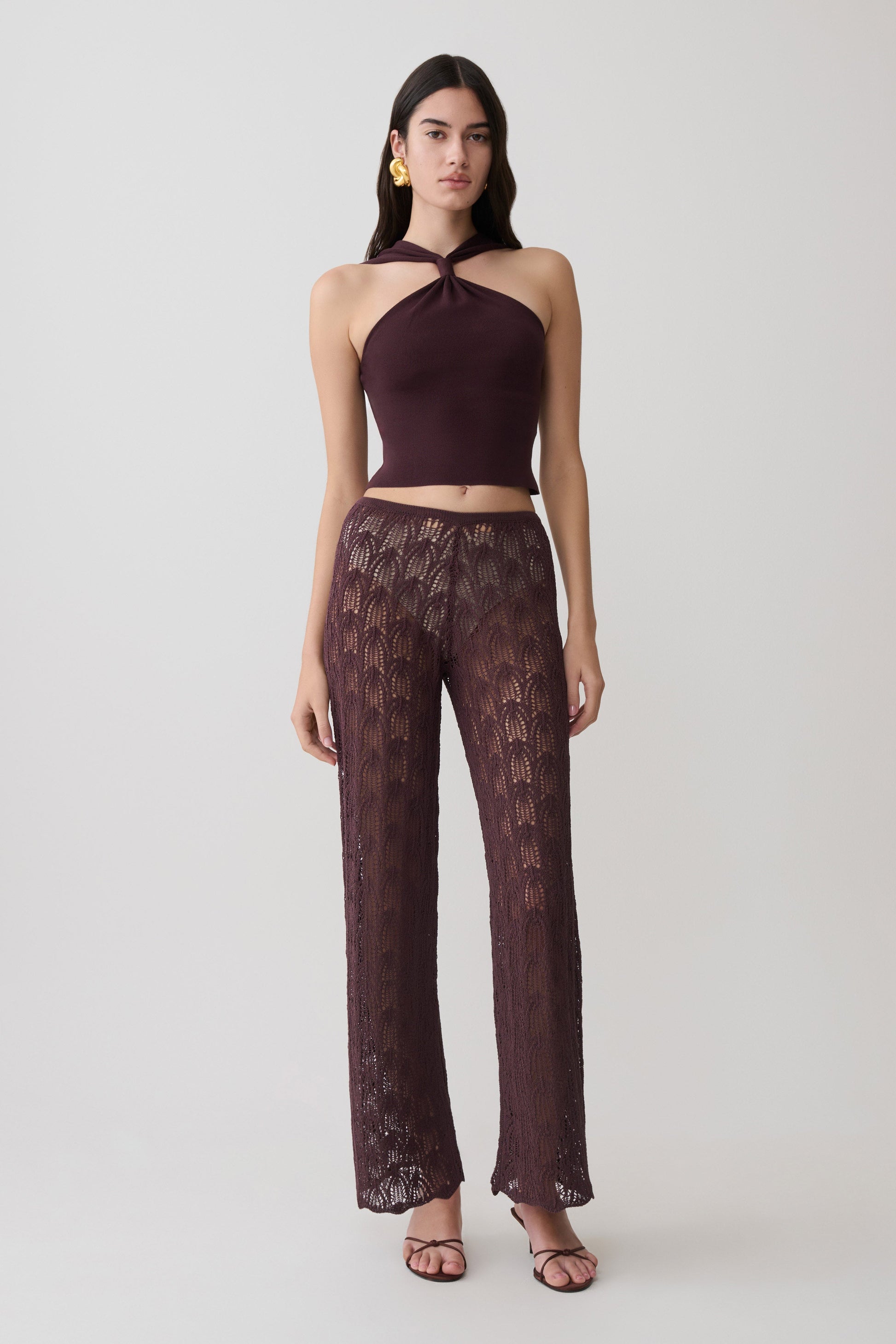Woman wearing brown crochet pants.