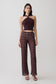 Woman wearing brown crochet pants.