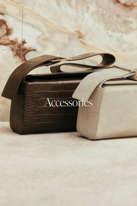 Two handbags on a marble surface.