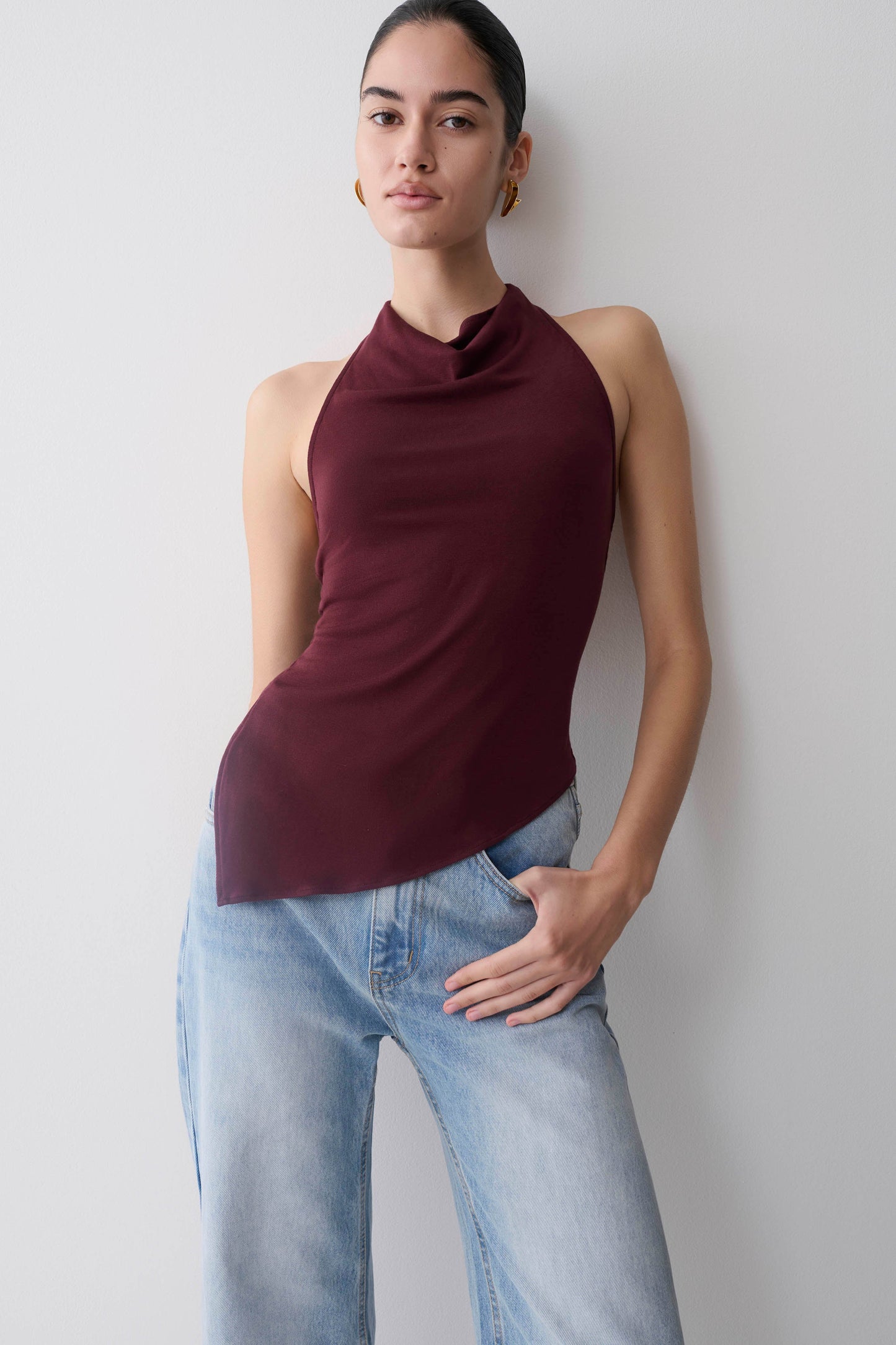 Woman wearing a burgundy relaxed sheer halter top.