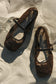 Brown lace applique flats.