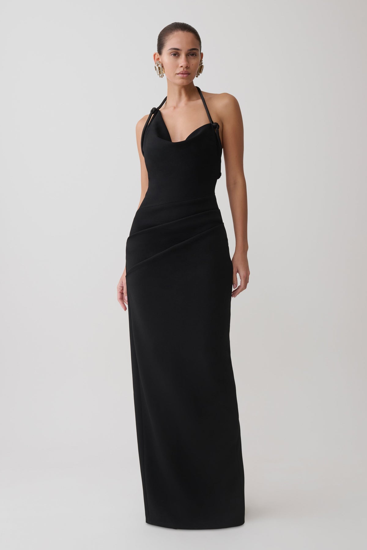 Woman wearing a black halter maxi dress.