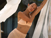 Image of woman in apricot crochet set.