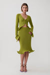 A model wearing a matching olive green knit two-piece set consisting of a long-sleeve cardigan with a front cutout and flared cuffs, and a fitted midi skirt with a ruffled hem, paired with brown strappy heels against a light gray studio background.