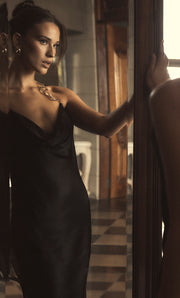 Image of woman in black maxi dress.