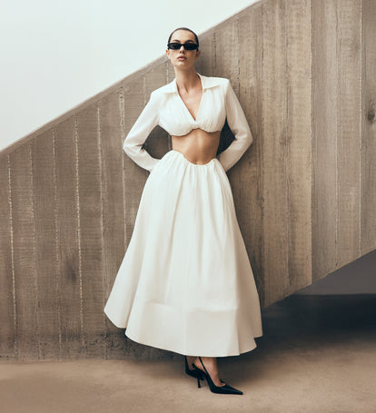 Image of woman in a white set.